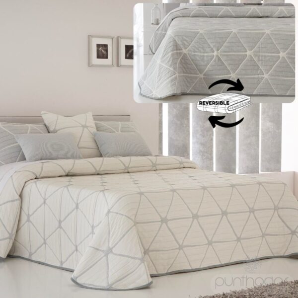 Colcha reversible GEOX en color gris sobre cama.
